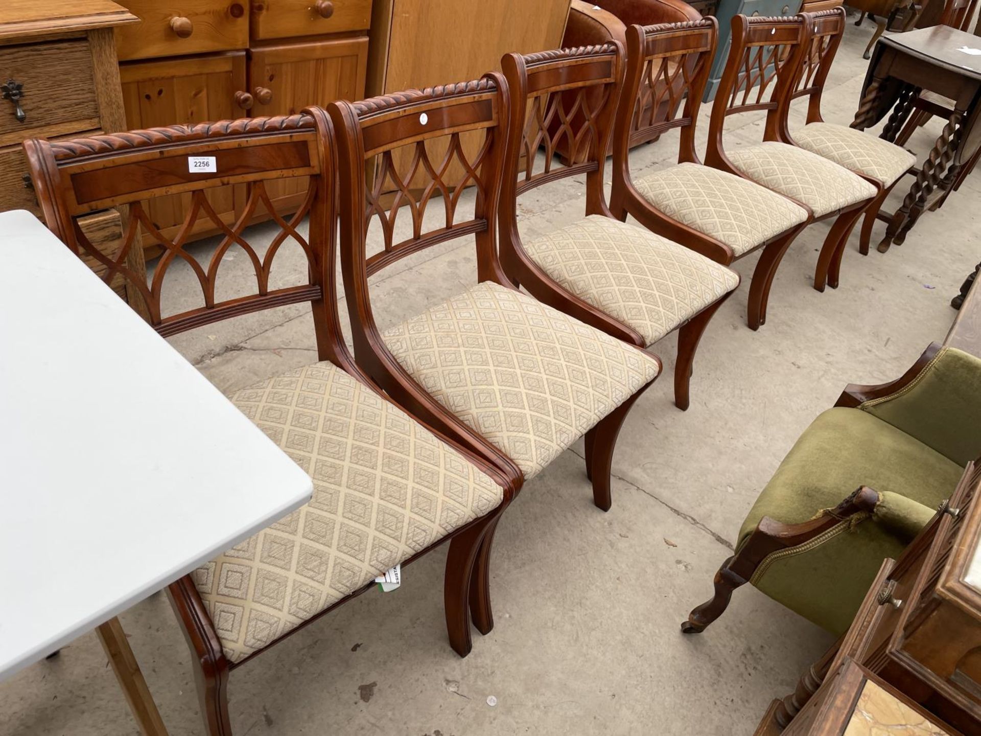 A SET OF SIX REGENCY STYLE YEW WOOD CROSSBANDED DINING CHAIRS