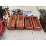 A GROUP OF FOUR WOODEN PLANTER TROUGHS
