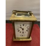 A FRENCH BRASS CARRIAGE CLOCK WITH WHITE ENAMEL DIAL AND SECONDHAND FEATURE (KEY) - 11CM HIGH