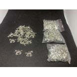 FOUR BAGS CONTAINING WHITE METAL HORSE CHARMS