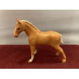 A BESWICK PALAMINO FOAL WITH TAIL DOWN