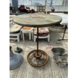 A VINTAGE INDUSTRIAL STYLE HIGH TABLE WITH COG BASE