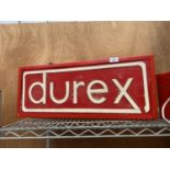 AN ILLUMINATED 'DUREX' SIGN