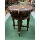 A VINTAGE ROUND LEATHER BUTTONED PIANO STOOL
