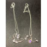 TWO SILVER NECKLACES WITH PENDANTS TO INCLUDE A CUBE AND A SWIRL WITH STONES AND MATCHING EARRINGS