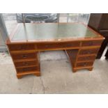 A REPRODUCTION YEW WOOD TWIN PEDESTAL DESK ENCLOSING NINE DRAWERS WITH INSET LEATHER TOP 60" X 36"
