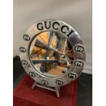 A CIRCULAR CHROME 'GUCCI' TABLE MIRROR D:25CM