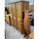 A DUCAL PINE TRIPLE WARDROBE AND THREE PINE BED ENDS