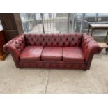 AN OXBLOOD LEATHER LOW BUTTON BACK CHESTERFIELD THREE SEATER SOFA
