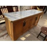 A LARGE PINE FRAMED FOUR DOOR KITCHEN BASE UNIT WITH LATER TILED TOP, 67x21.5x35"