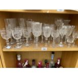 A LARGE COLLECTION OF CUT GLASSES TO INCLUDE WINE GLASSES AND SHERRY GLASSES