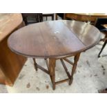 AN EARLEY 20TH OVAL OAK GATE LEG TABLE ON TURNED LEGS