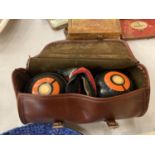 A PAIR OF BOWLING BOWLS IN A CARRYING CASE