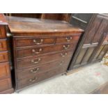 A GEORGE III OAK AND CROSSBANDED CHEST OF TWO SHORT DRAWERS AND THREE GRADUATED DRAWERS