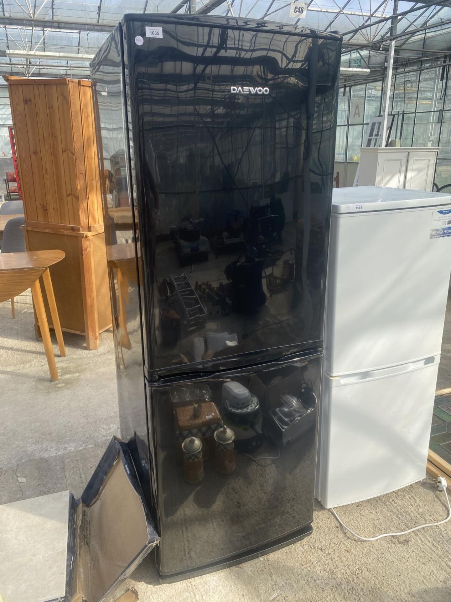 A BLACK DAEWOO FRIDGE FREEZER - BELIEVED WORKING BUT NO WARRANTY