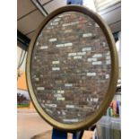 A GILT FRAMED OVAL MIRROR (44 X 34 CMS)