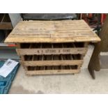 AN INDUSTRIAL STYLE OCCASIONAL TABLE WITH LOWER WINE RACK CREATED USING POTATO SPRTIITNG BOXES