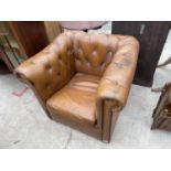 A LEATHER CHESTERFIELD CLUB TYPE CHAIR ON BUN FRONT LEGS