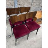 A SET OF FOUR RETRO BLACK FRAMED DINING CHAIRS WITH SHAPED TEAK BACKS AND BURGUNDY SEATS