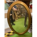 A LARGE GOLD PAINTED FRAMED OVAL MIRROR WITH CHAIN (A/F ON REVERSE) H: APPROX 84CM