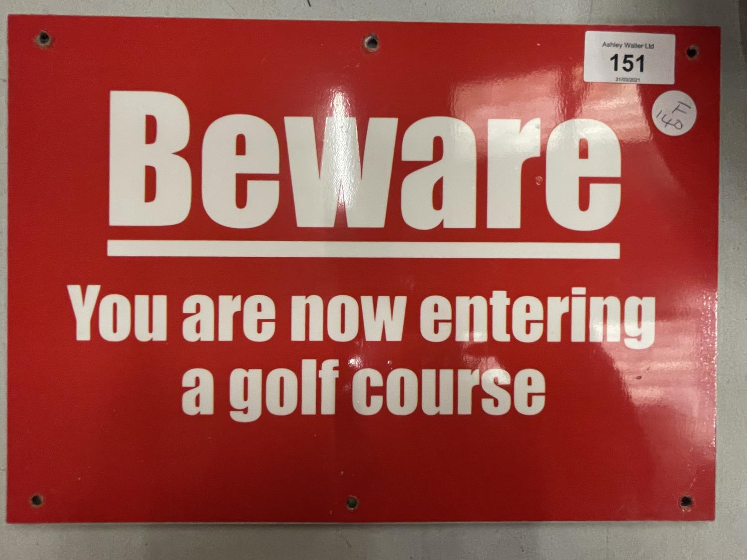 A POLYVINYL BEWARE SIGN 'YOU ARE NOW ENTERING A GOLF COURSE'