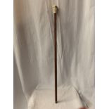 A WOODEN WALKING STICK INCORPORATING A COMPASS IN THE HANDLE
