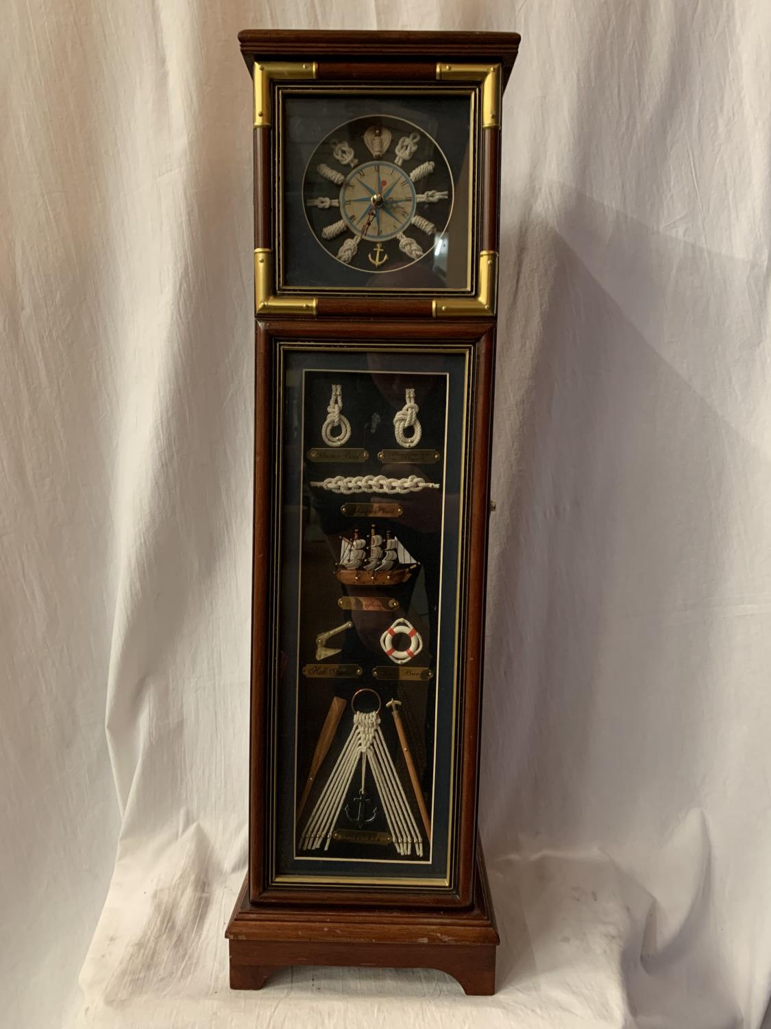 A TALL NAUTICAL CLOCK INCORPORATING FIVE INTERNAL SHELVES AND A COMPASS H: 80CM