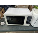 A WHITE KENWOOD MICROWAVE OVEN BELIEVED IN WORKING ORDER BUT NO WARRANTY