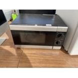 A BLACK TESCO MICROWAVE OVEN BELIEVED IN WORKING ORDER BUT NO WARRANTY