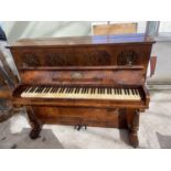 A WALNUT CASED OVERSPRUNG PIANO BEARING LOCKE & CO MANCHESTER