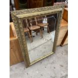 A MODERN GILT FRAMED WALL MIRROR