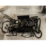A CONTAINER OF COSTUME JEWELLERY TO INCLUDE MAINLY NECKLACES