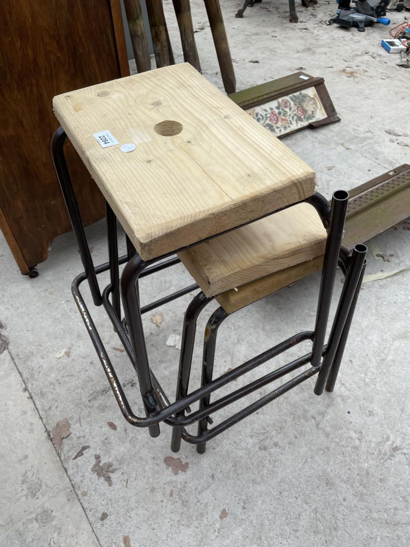 THREE TUBULAR STACKING STOOLS