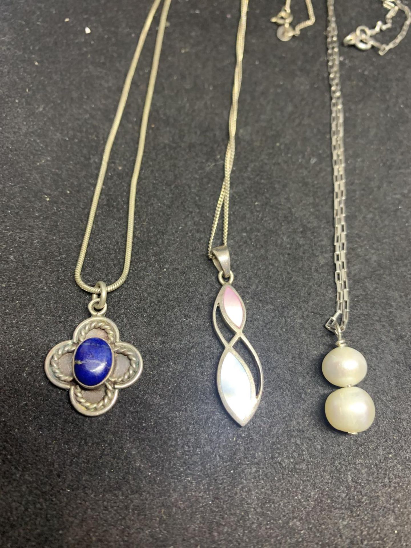 SIX MARKED SLIVER PENDANTS ON CHAINS TO INCLUDE A CLEAR STONE CROSS, HEART, BLUE STONE, PEARL ETC - Image 2 of 3