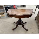 A VICTORIAN WALNUT FOLD OVER CARD TABLE ON QUATREFOIL BASE W: 35 INCHES (LACKING BAIZE)