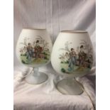 A PAIR OF LARGE BRANDY BALLOON GLASSES DECORATED WITH GEISHA GIRLS BEEN CONVERTED TO TABLE LAMPS -