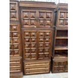 A SPANISH WALNUT HEAVILY PANELED WALL UNIT WITH TWO CUPBOARDS AND THREE DRAWERS TO THE BASE (W: 35.5