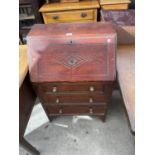 AN OAK BUREAU WITH FALL FRONT AND THREE DRAWERS