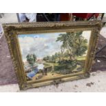 A GILT FRAMED OIL ON CANVAS OF A CANAL SCENE