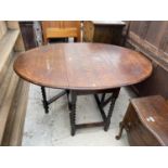 AN EARLY 20TH CENTURY OAK BARLEY-TWIST GATE-LEG DINING TABLE