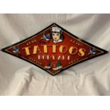 A METAL DIAMOND SHAPED 'TATTOOS' SIGN - 71CM X 36CM (POINT TO POINT)