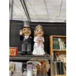 A PAIR OF RESIN WEDDING GNOMES DEPICTING A BRIDE AND GROOM