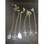 SIX SILVER NECKLACES WITH PENDANTS TO INCLUDE CLEAR STONE FLOWERS, CROSS ETC
