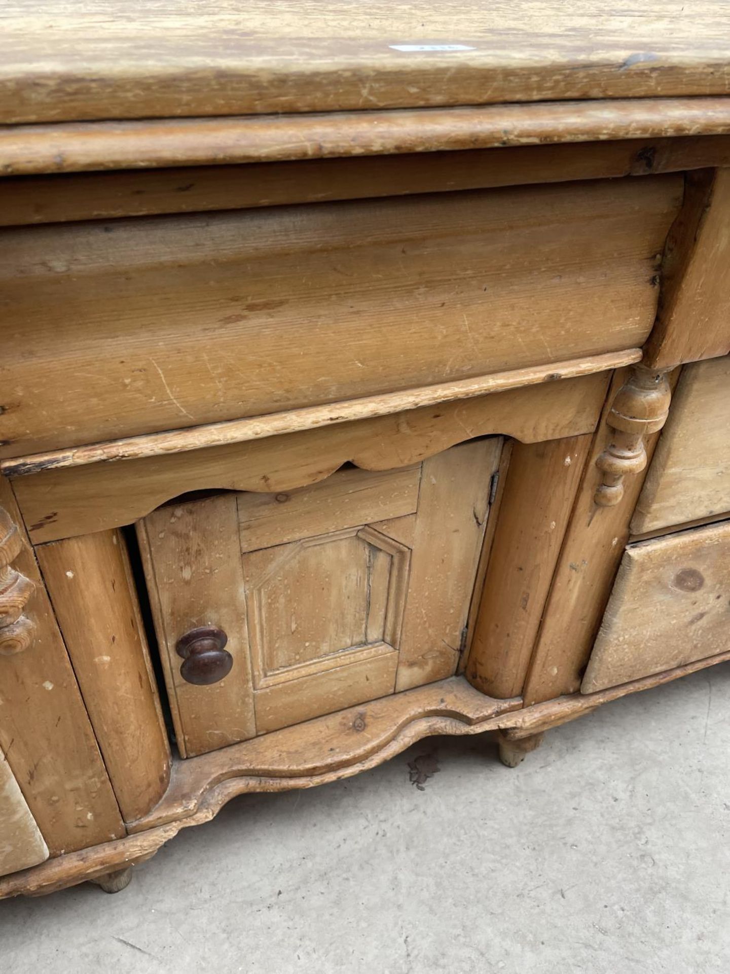 A VICTORIAN PINE KITCHEN DRESSER BASE ENCLOSING SIX DRAWERS AND CENTRAL CUPBOARD, 61" WIDE - Image 4 of 5