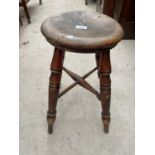 A VICTORIAN ROUND STOOL ON FOUR TURNED LEGS