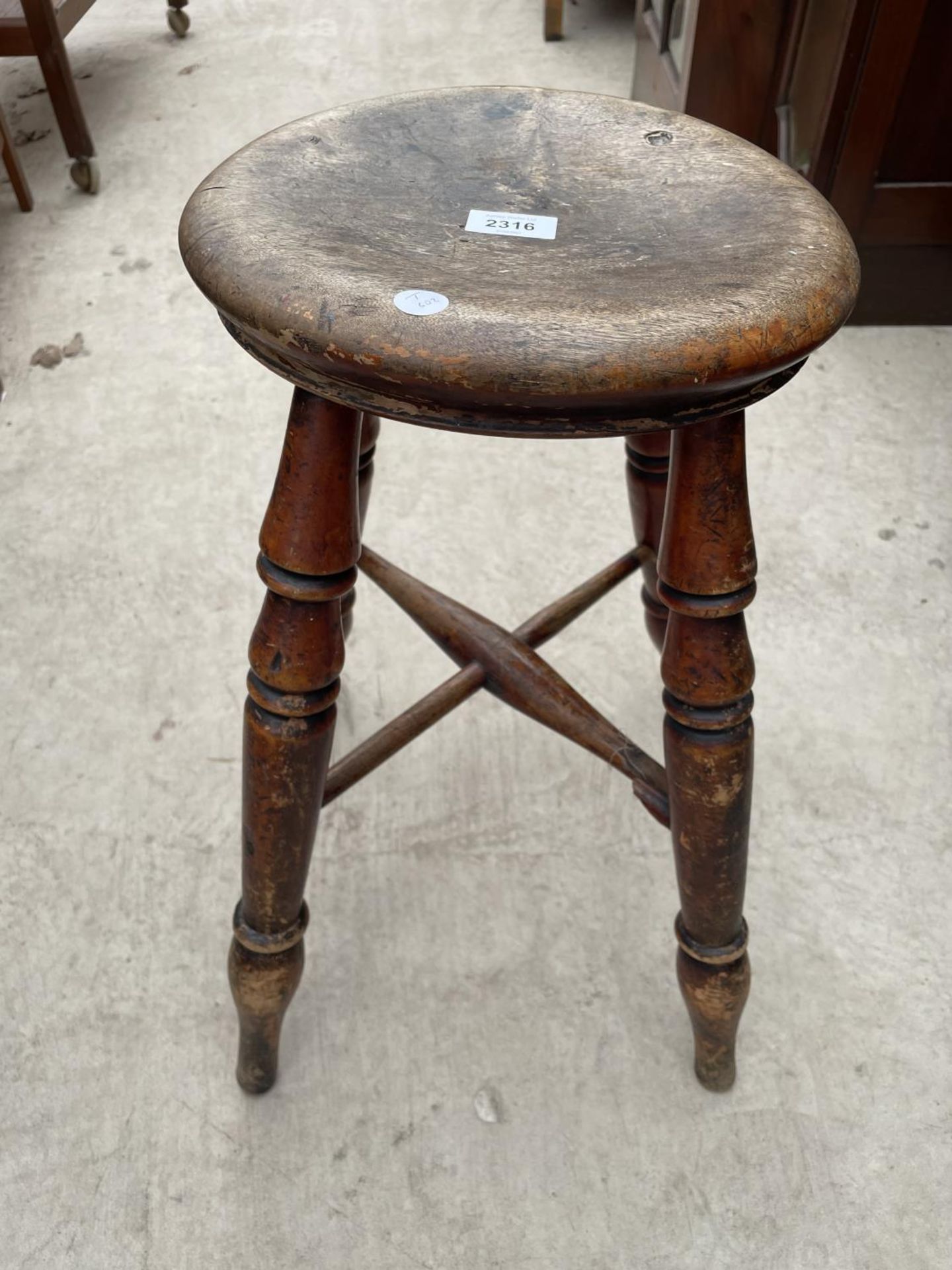 A VICTORIAN ROUND STOOL ON FOUR TURNED LEGS