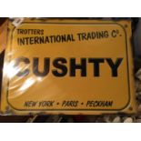 A METAL TROTTERS 'CUSHTY' SIGN