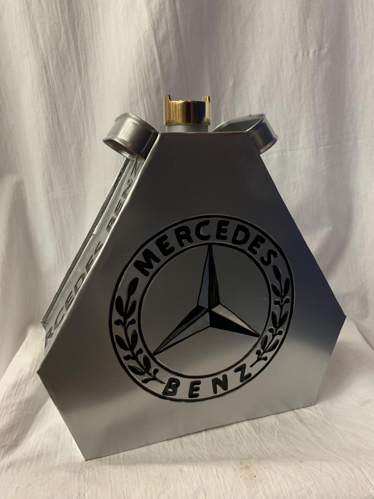 A SILVER 'MERCEDES BENZ' PETROL CAN WITH BRASS LID