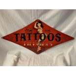 A METAL DIAMOND SHAPED 'TATTOOS' SIGN - 71CM X 36CM (POINT TO POINT)