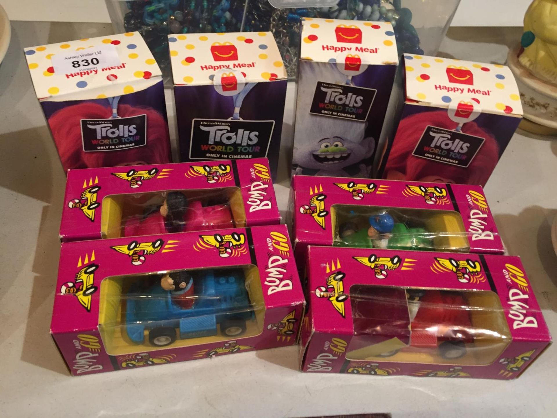 FOUR BROOKE BOND BUMP AND GO TOY MODEL CARS AND FOUR BOXES OF TROLLS